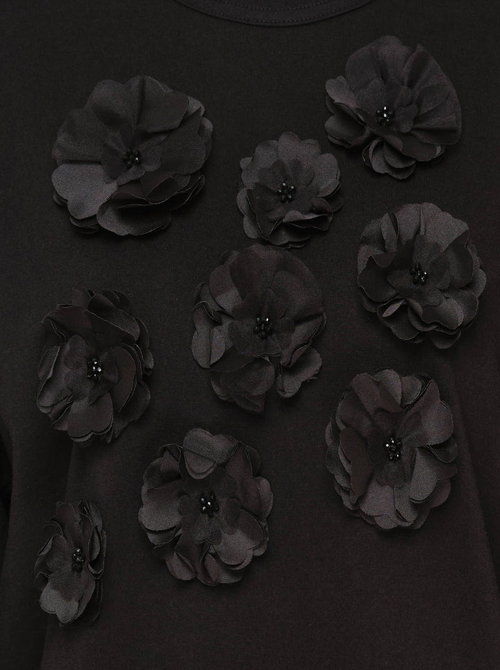 Tao black long sleeve crew neck top with nine tonal satin 3D floral appliqués and bead centres scattered across the chest, shot flat on a white background - view 3