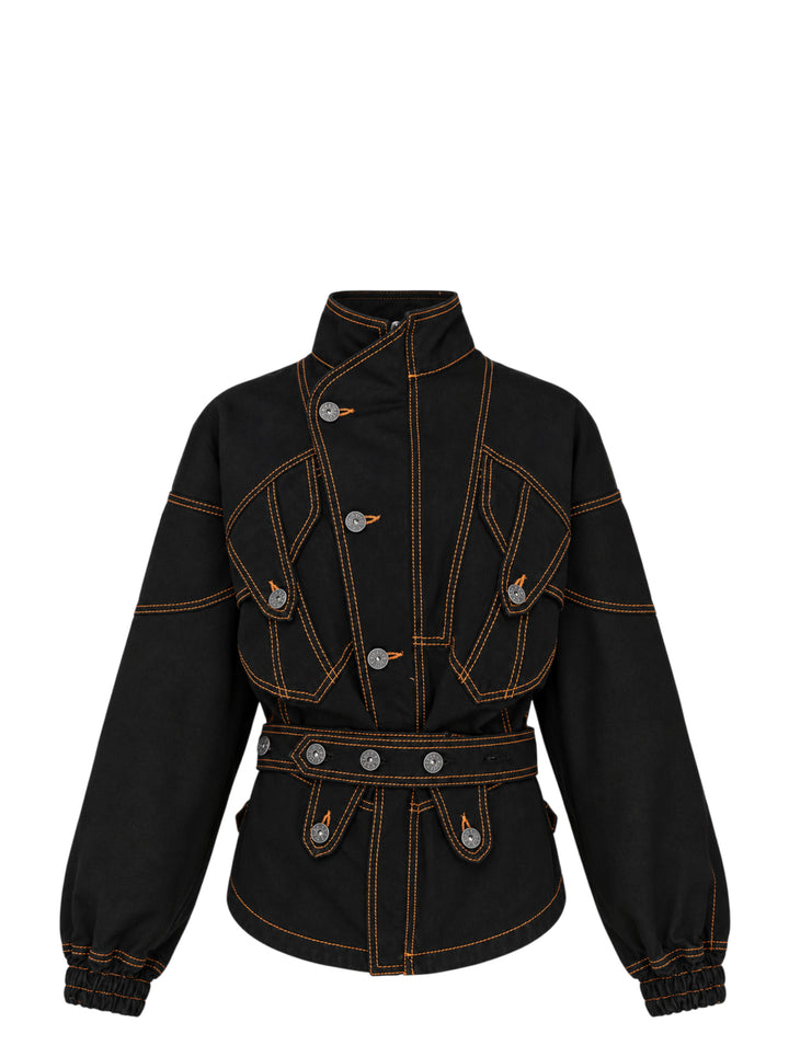 Vaquera women's black denim jacket with orange contrast topstitching, stand collar, button-tab pocket flaps, belted waist and elasticated cuffs