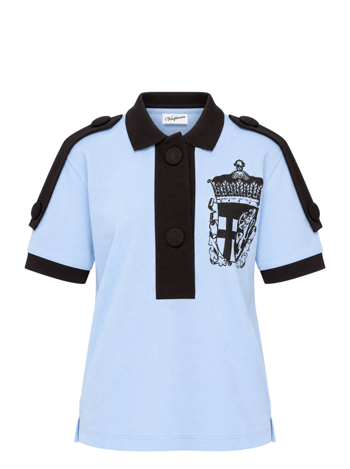 Vaquera light blue piqué polo with black collar, placket, epaulettes and cuffs, featuring a black heraldic crest print on the chest