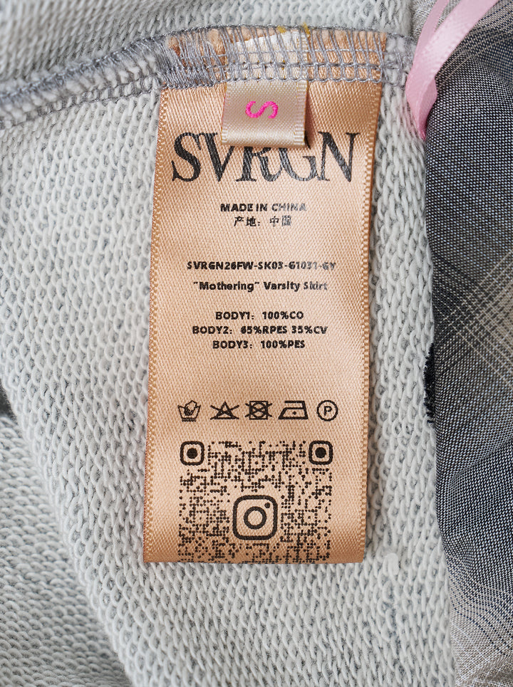 Sultry Virgin Born Mommy Varsity Skirt in heather grey sweatshirt fleece with pink collegiate lettering, drawstring waist, plaid fold-over lining, and front patch pocket - view 3