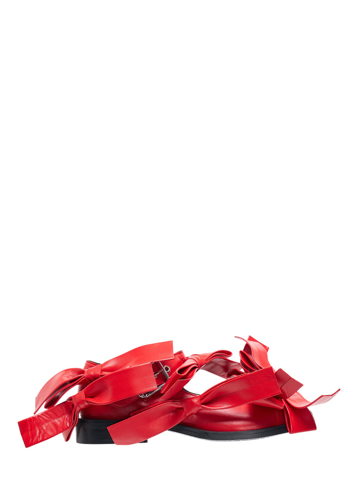Pair of Phileo Mary Jane Bows flats in red leather with oversized sculptural bows and buckle strap on a black sole