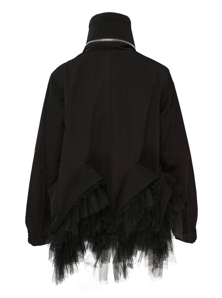 Noir Kei Ninomiya black oversized long sleeve jacket with high drawstring neck, silver zip closures, angled chest zip pockets, and layered black tulle ruffle hem, displayed flat on a white background - view 2