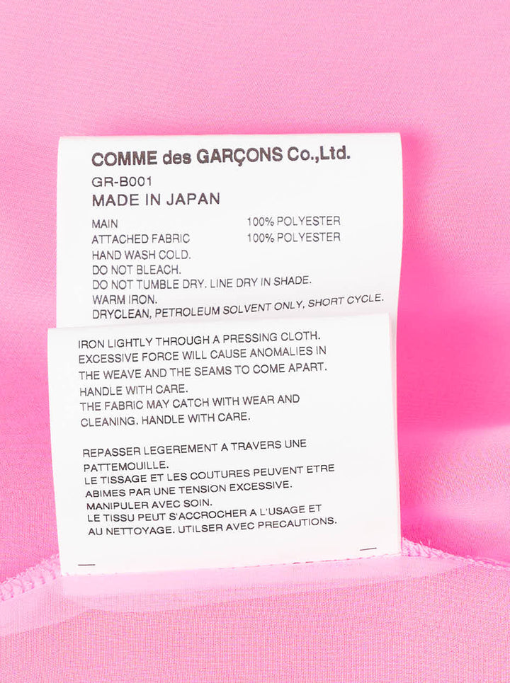 Comme des Garçons sheer fuchsia pink longline tailored blouse with point collar, white button-front fastening, chest patch pocket, and structured cuffs - view 3