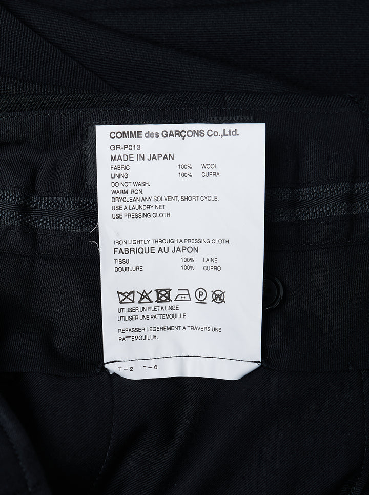 Comme des Garçons black wide leg pleated trousers with high waist, double front pleats, and deep turned-up cuffs, photographed flat on a white background - view 3