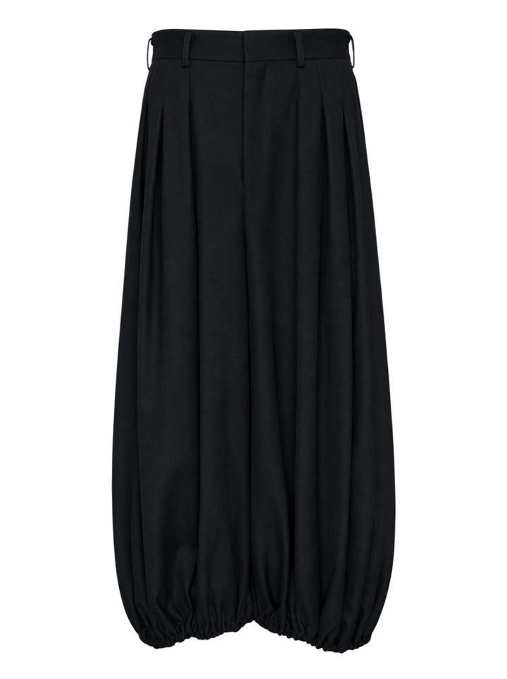 Comme des Garçons black balloon trousers with pleated high waist, voluminous silhouette, and elasticated gathered hems, shot flat on white background