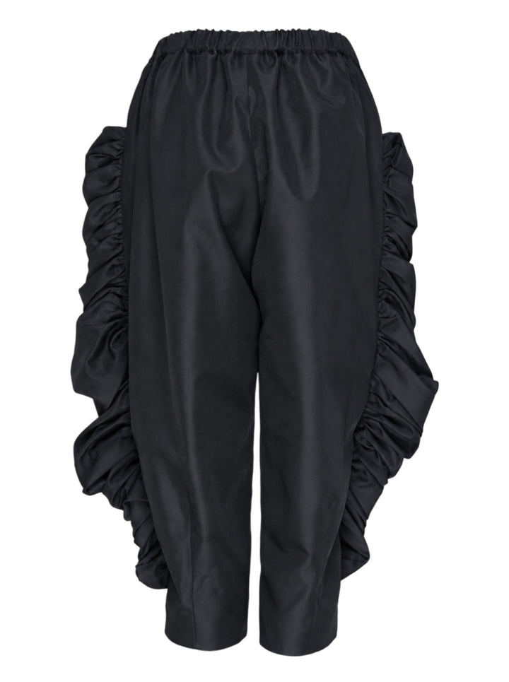 Comme des Garçons wide-leg black pants with dramatic ruched frill panels along both side seams and an elasticated waistband, displayed flat against a white background - view 2