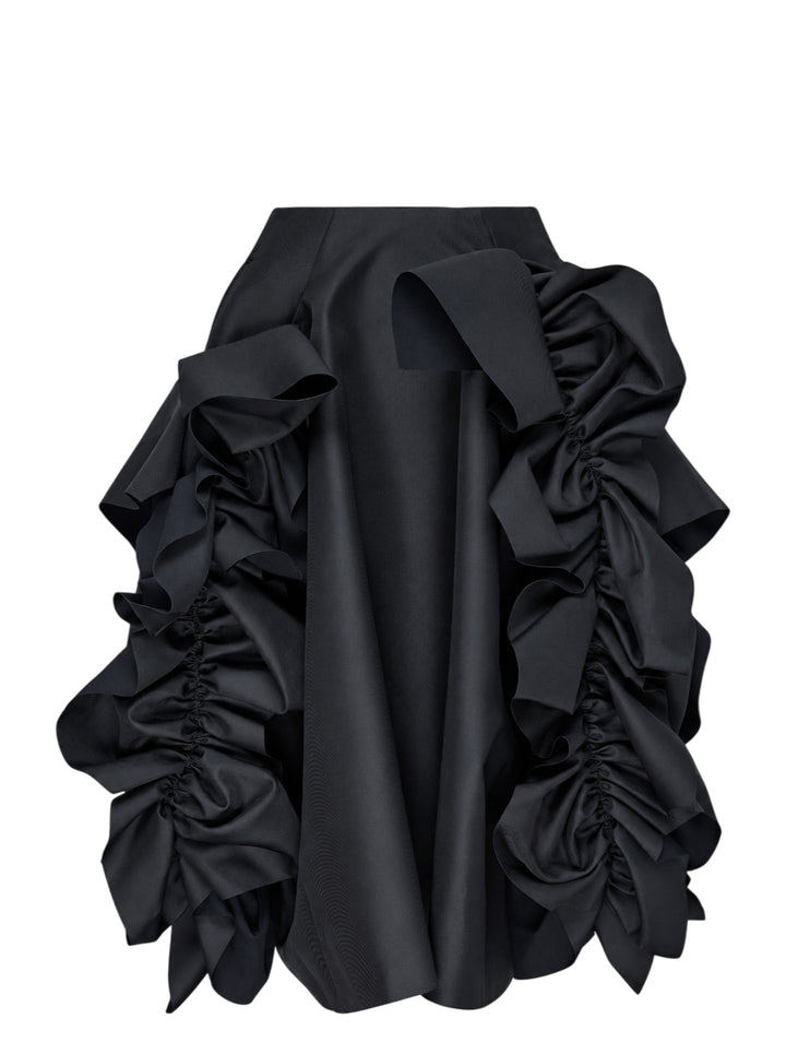 Comme des Garçons black asymmetrical midi skirt with voluminous gathered ruffle panels on both sides and a smooth structured centre panel, photographed on a white background