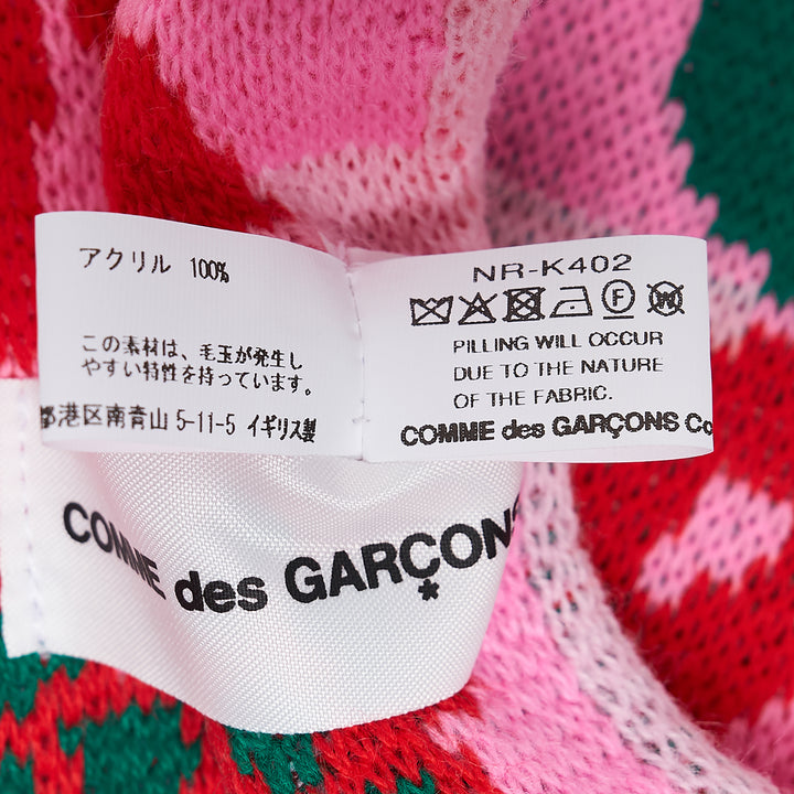 Comme des Garçons Girl knitted acrylic stole in pink gingham with teal snake motifs, red cross and cherry blossom detailing, GIRL logo lettering, and red fringe trim at both ends