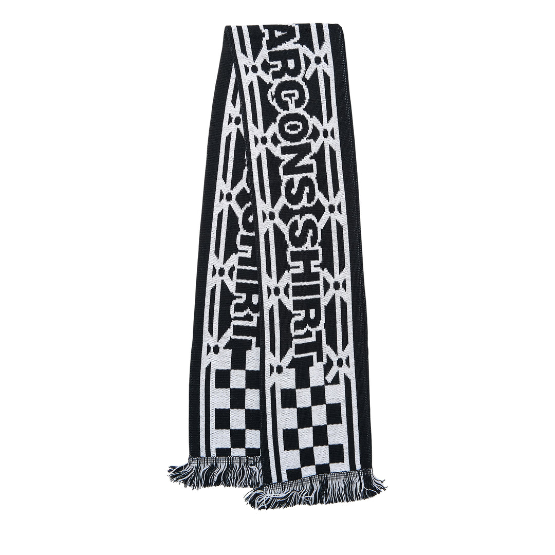 Comme des Garçons Girl holiday knitted acrylic stole with all-over reindeer and tree jacquard motifs in red, pink, and white, with fringe trim at both ends