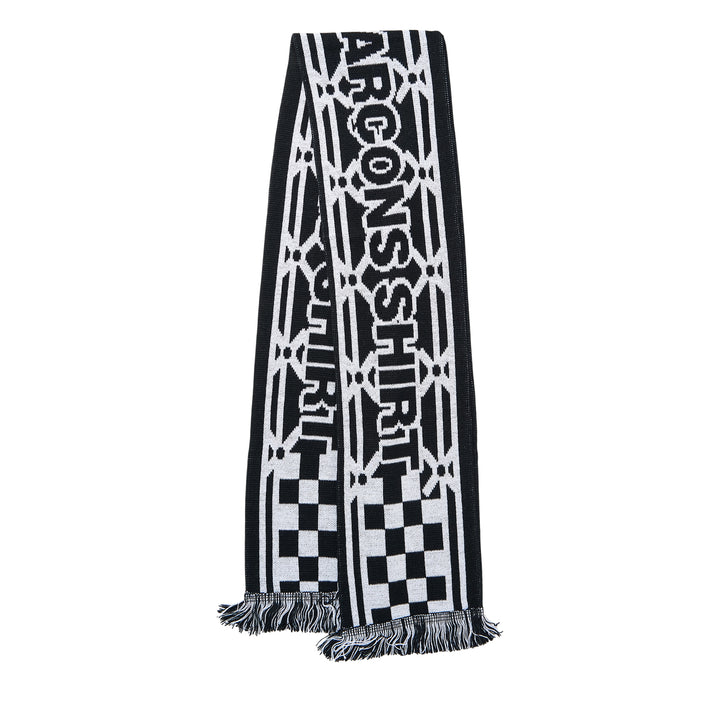 Comme des Garçons Girl holiday knitted acrylic stole with all-over reindeer and tree jacquard motifs in red, pink, and white, with fringe trim at both ends