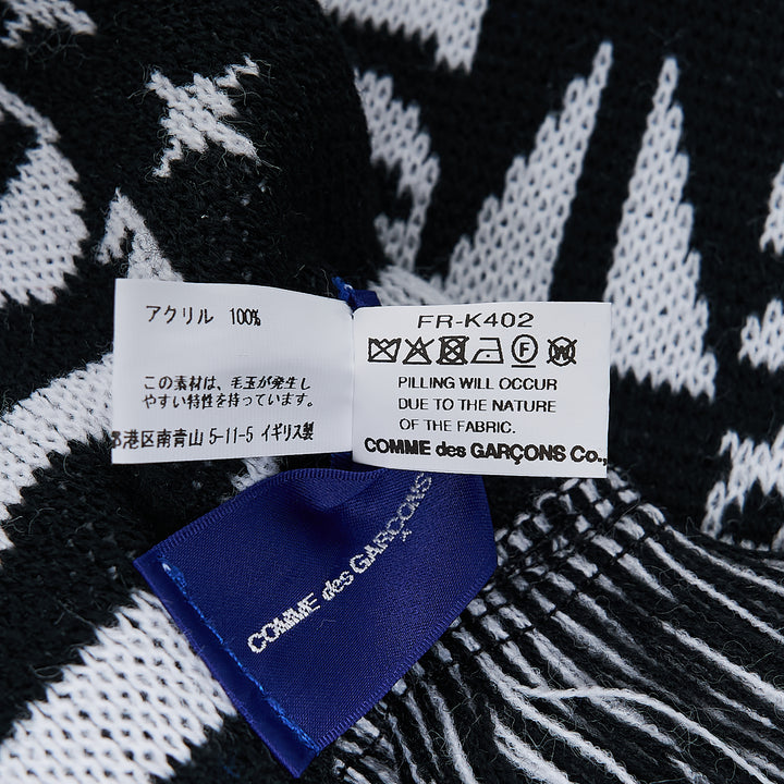 Comme des Garçons Girl knitted acrylic stole in pink gingham with teal snake motifs, red cross and cherry blossom detailing, GIRL logo lettering, and red fringe trim at both ends