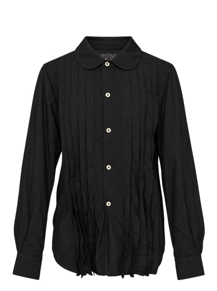 Black pleated button-down shirt with rounded collar, pale buttons and frayed pleated hem by Comme des Garçons Comme des Garçons