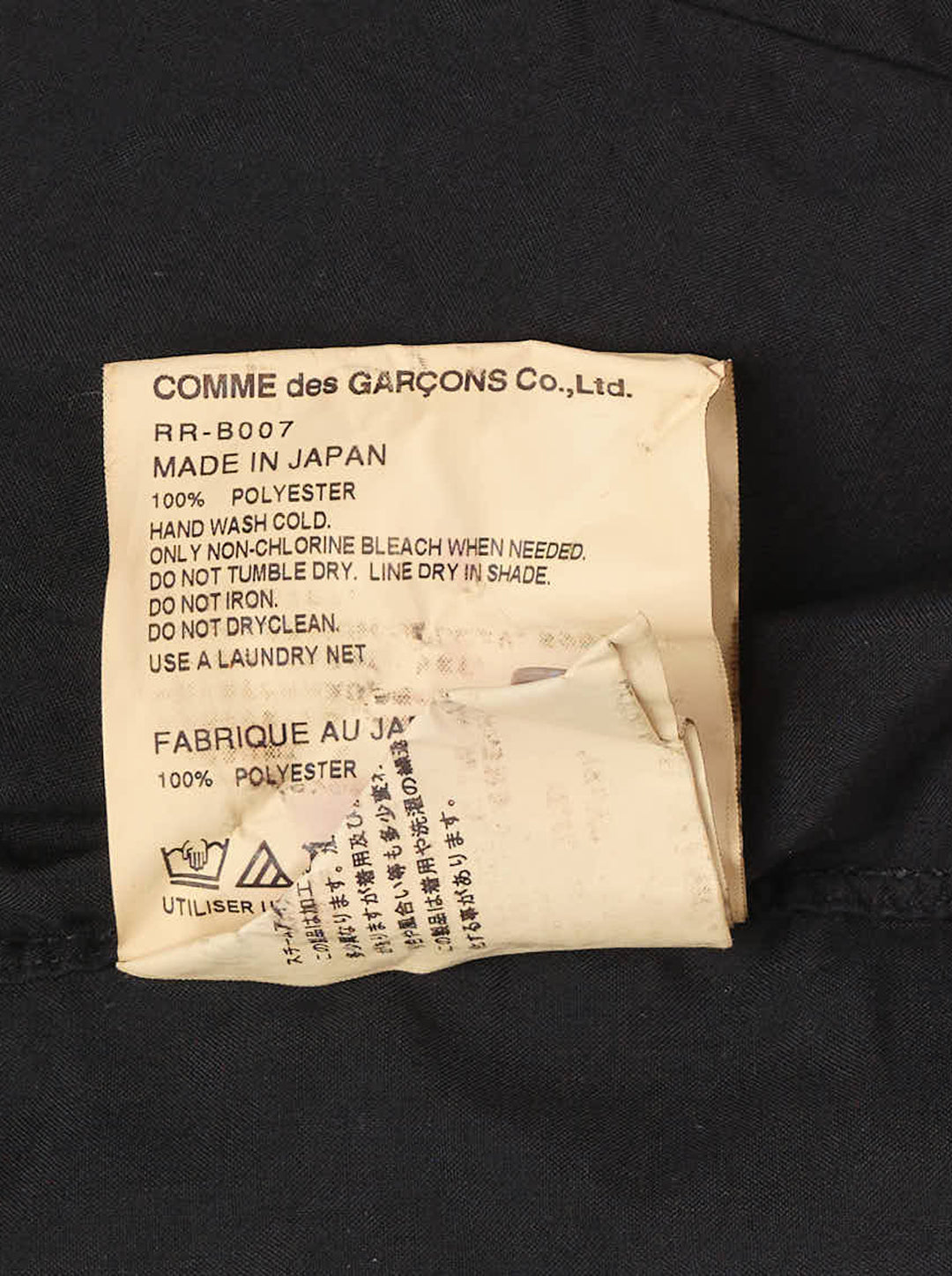 Black pleated button-down shirt with rounded collar, pale buttons and frayed pleated hem by Comme des Garçons Comme des Garçons - view 3
