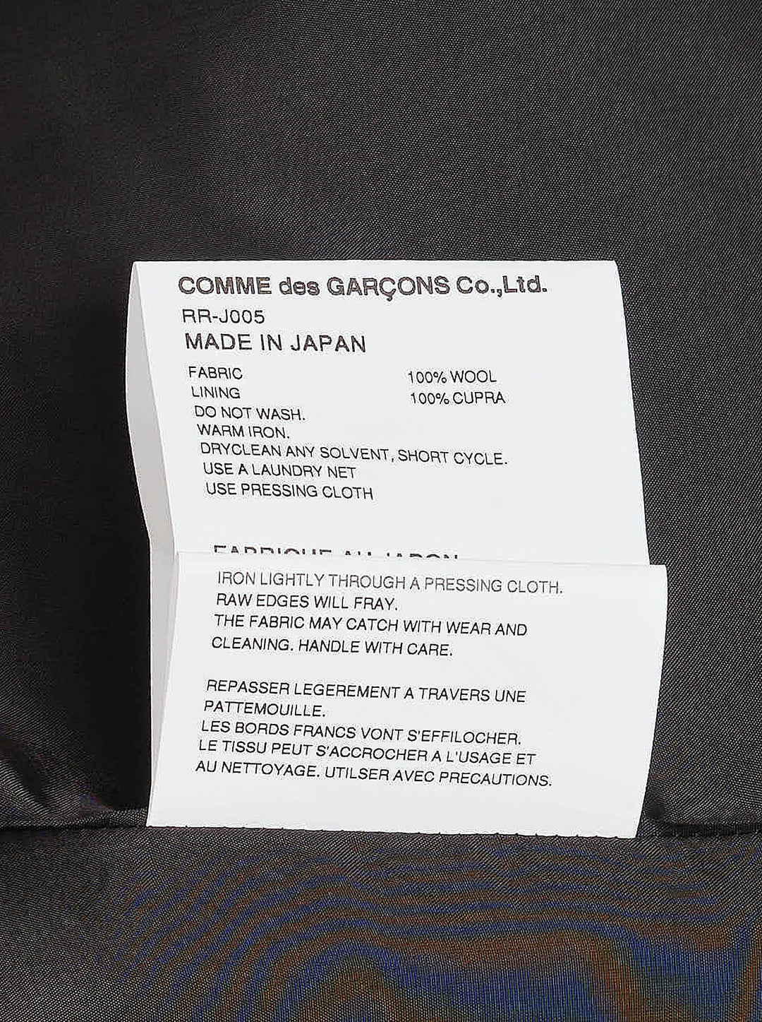Comme des Garçons Comme des Garçons charcoal grey single-breasted tailored blazer with deconstructed double-lapel detail and three-button closure, styled flat on a white background - view 4