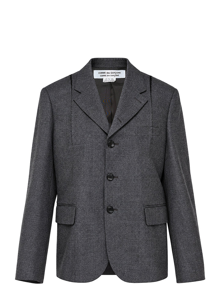 Comme des Garçons Comme des Garçons single-breasted tailored blazer in mid-grey mélange wool, featuring notched lapels, three-button closure, chest welt pocket, and twin flap hip pockets, shown flat on a white background.