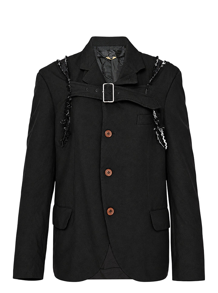 Comme des Garçons Comme des Garçons black deconstructed single-breasted blazer with cross-body harness buckle strap, frayed shoulder trim, and contrast brown buttons, shown on a flat lay against a white background