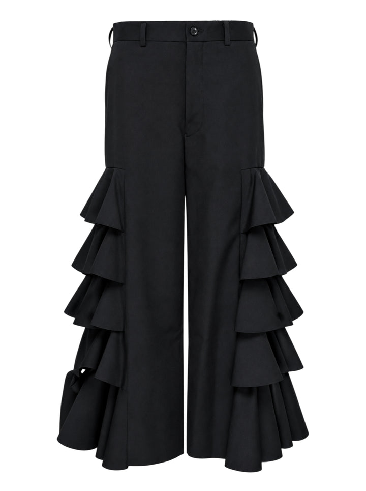 Black wide-leg cropped pants with cascading tiered ruffles down both sides, shown from the front against a white background