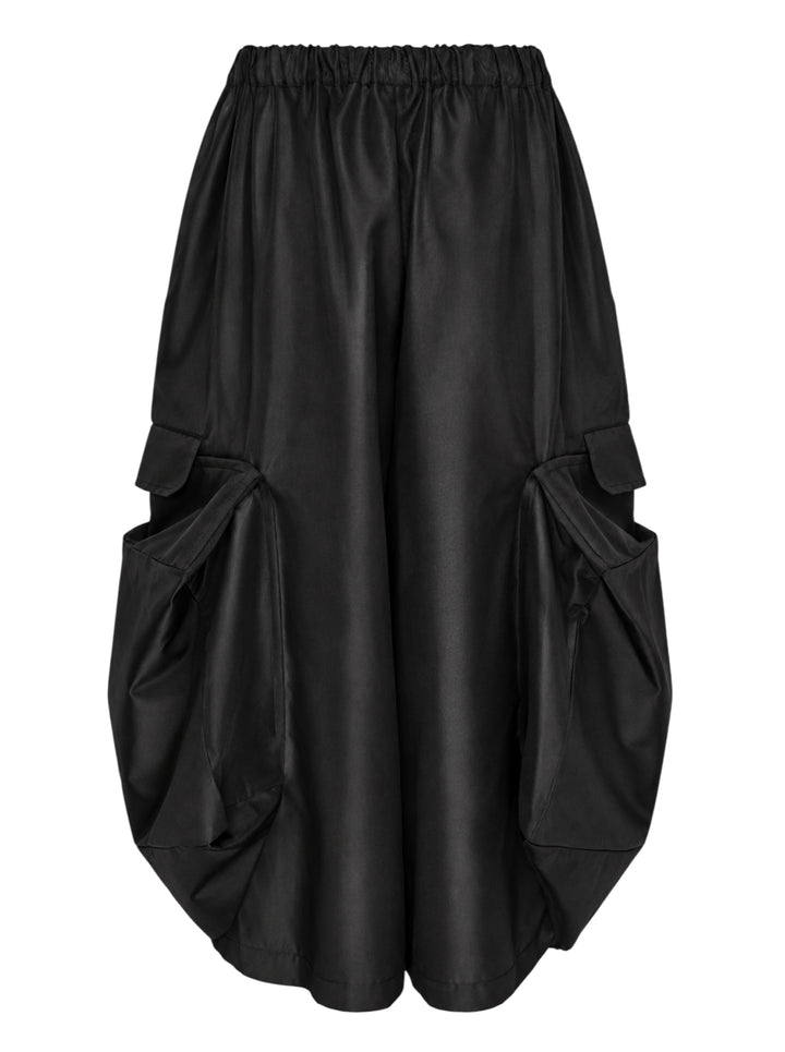 Black wide-leg Comme des Garçons Comme des Garçons pants with an elasticated gathered waist and oversized draped cargo pockets, shown from the front - view 2