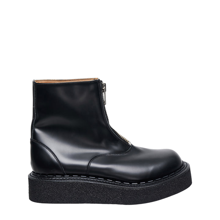 Comme des Garçons Homme Plus x George Cox black polished leather ankle boot with gold-tone front zip closure and chunky black crepe platform sole with white topstitching