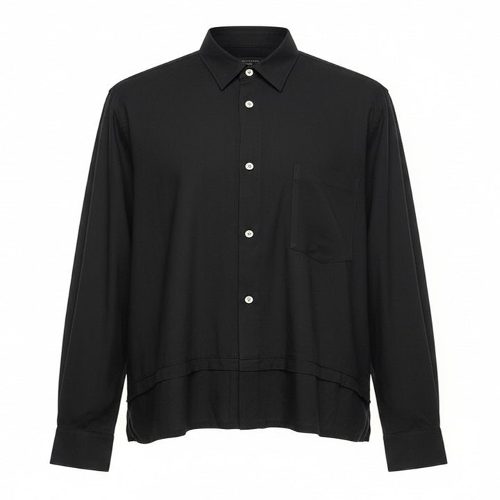 Comme des Garçons Homme Plus black polyester broad long sleeve shirt with layered hem, chest pocket, and mother-of-pearl button fastening, front view