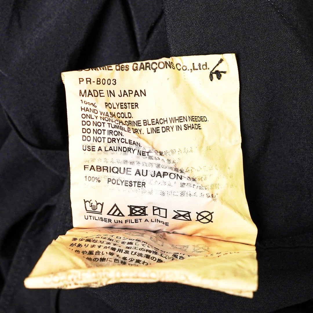 Comme des Garçons Homme Plus black polyester broad long sleeve shirt with layered hem, chest pocket, and mother-of-pearl button fastening, front view - view 3