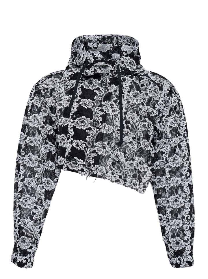 Comme des Garçons Homme Plus cropped hooded jacket in black and white floral embroidered nylon tulle with asymmetric raw hem and drawstring hood