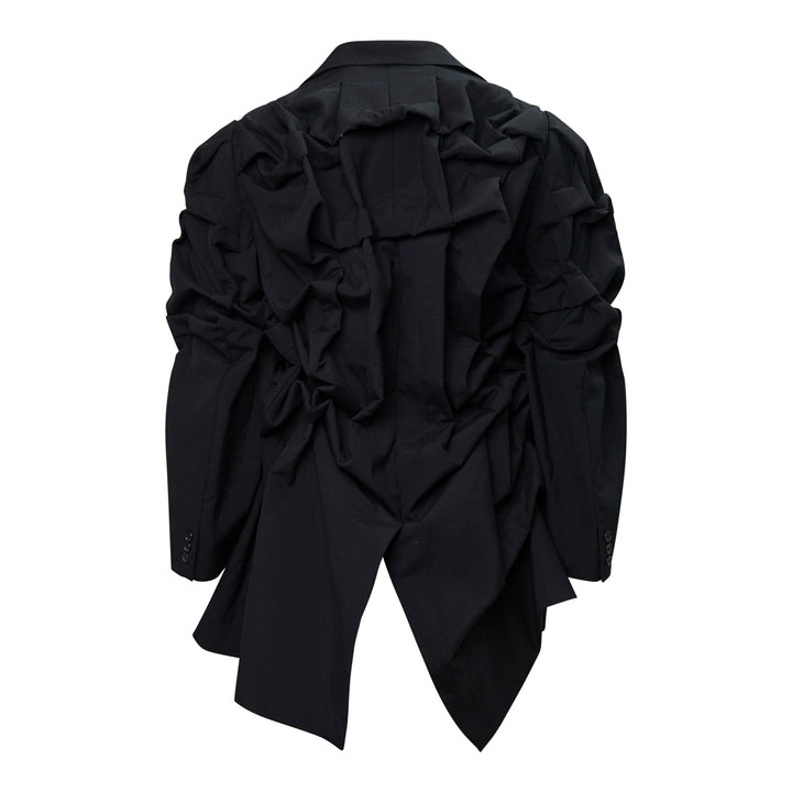 Comme des Garçons Homme Plus black wool tropical jacket with dramatic sculptural ruffles cascading across the chest and shoulders, long sleeves, and a notched lapel collar, displayed on a white background - view 2