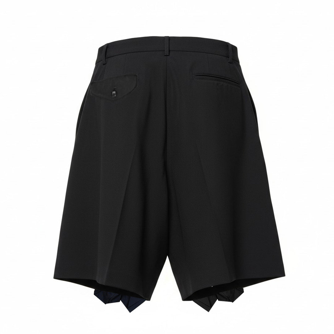 Comme des Garçons Homme Plus black wool tropical wide-leg shorts with cascading ruffle panels on the front, high-rise waistband with belt loops and single button fastening, on a white background - view 2