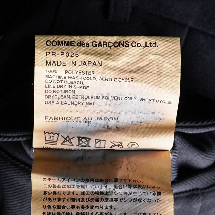 Comme des Garçons Homme Plus garment-dyed black polyester serge shorts with dramatic ruched ruffle detailing and structured waistband, front view - view 3
