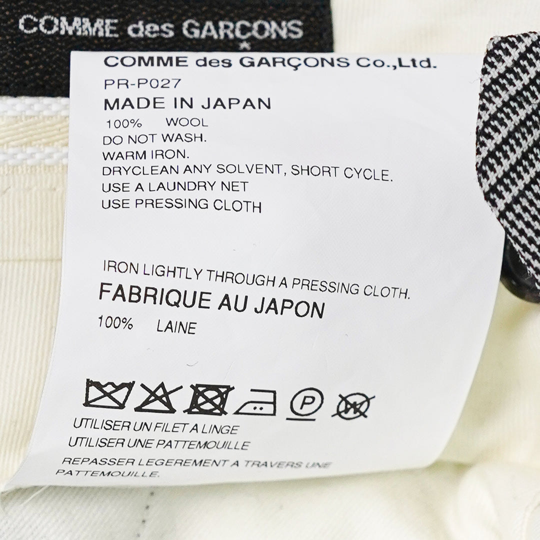 Comme des Garçons Homme Plus wool glen-check balloon pants in monochrome micro-houndstooth, featuring a dramatically voluminous upper leg gathered below the knee and tapering to a slim ankle, shown flat on white background - view 3
