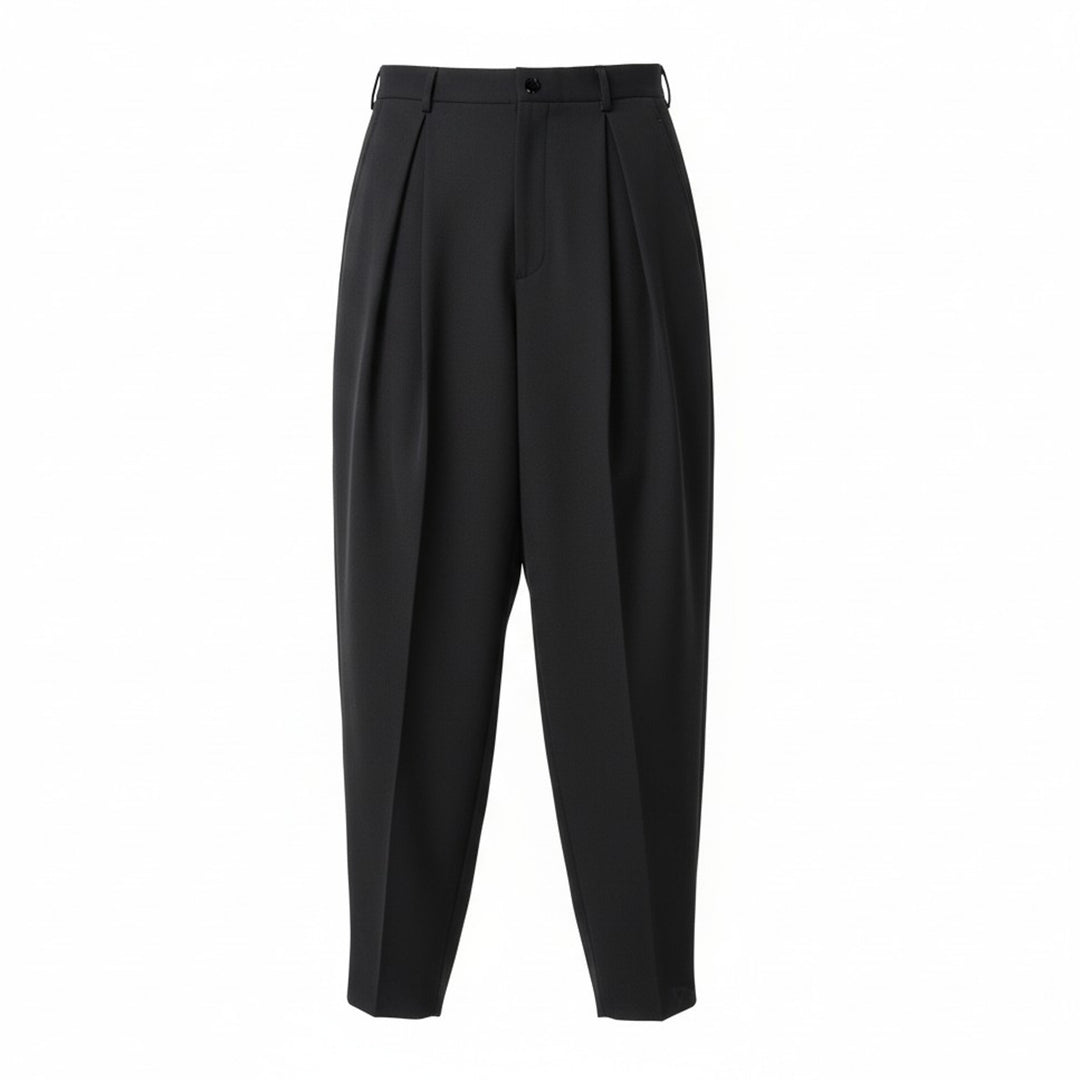 Comme des Garçons Homme Plus wool gabardine double-pleat high-rise tapered trousers in dark charcoal, flat lay on white background