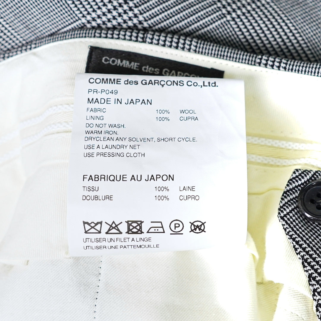 Comme des Garçons Homme Plus grey wool glen-check double-pleat tapered trousers on a white background, front view - view 3