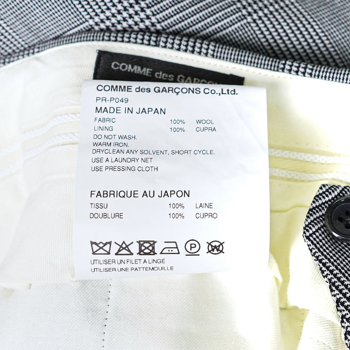 Comme des Garçons Homme Plus grey wool glen-check double-pleat tapered trousers on a white background, front view - view 3