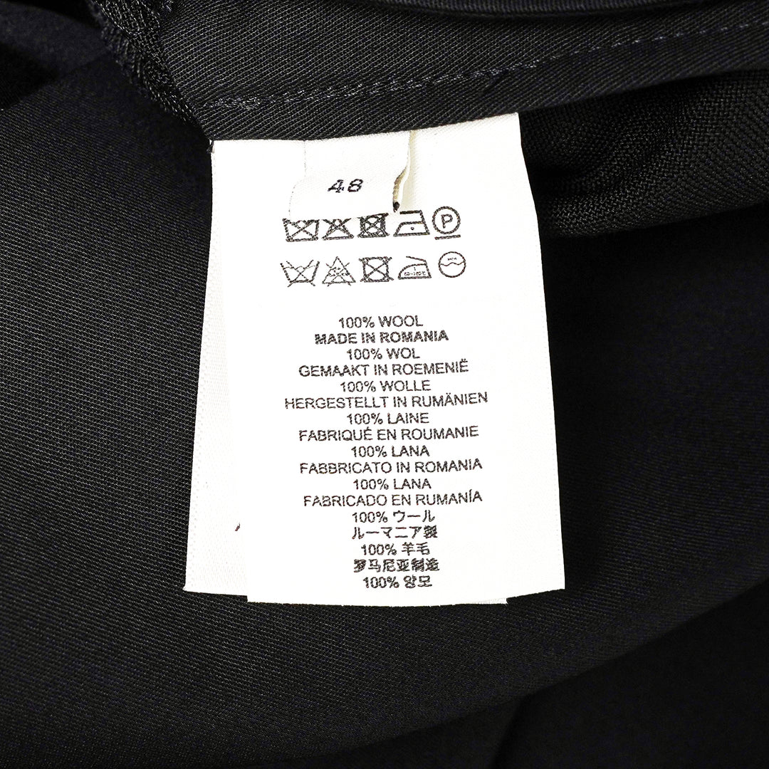 Dries Van Noten black pleated wrap kilt skirt with diagonal buckle waistband and asymmetric knife-pleated hem, shot on a white background - view 3