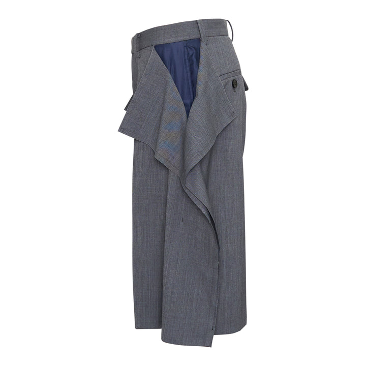 Undercover grey wool-blend tailored shorts with oversized draped side flaps revealing navy lining, featuring belt loops, pleated front, and concealed zip fly