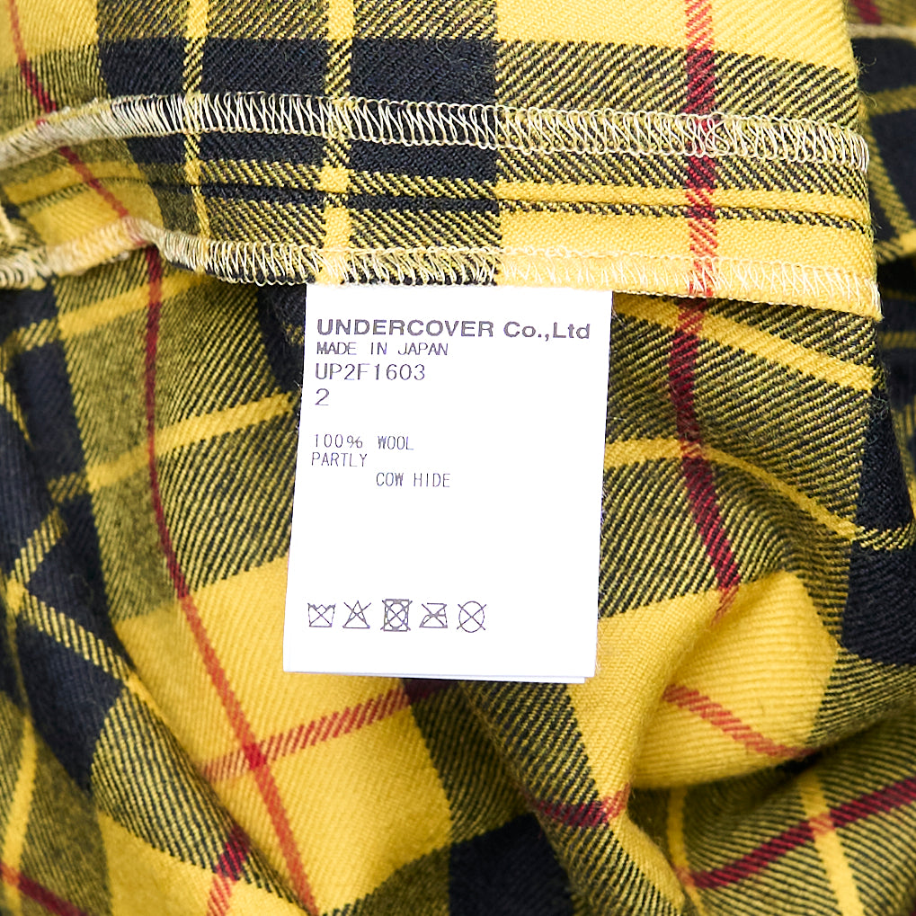 Undercover Checked Wrap Skirt in yellow MacLeod tartan with deep knife pleats and double leather buckle closure, midi length, on a white background