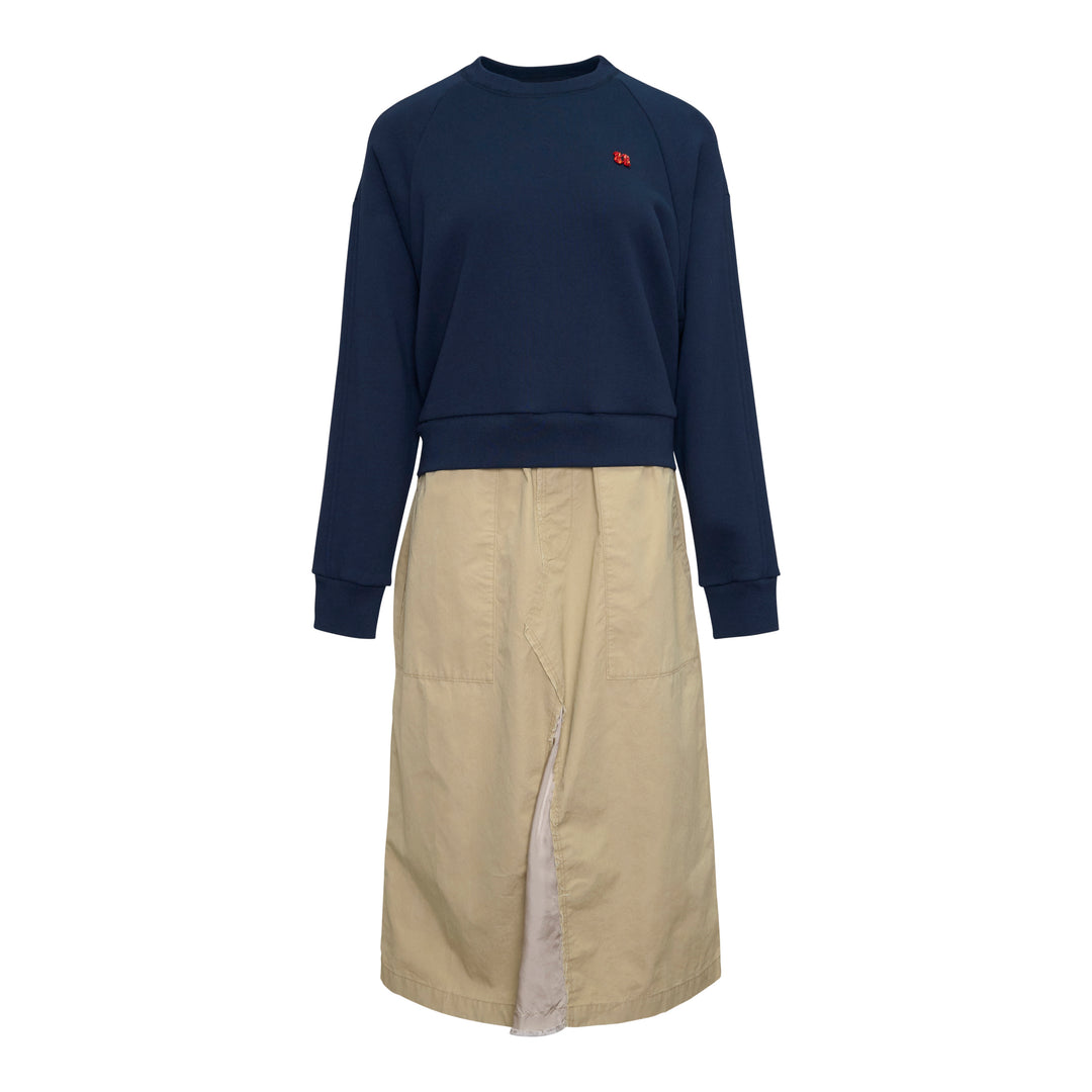 Undercover Trompe L'Oeil Sweater Dress featuring a navy raglan sweatshirt top with small embroidered chest motif over a khaki twill midi skirt with front vent and patch pocket, presented as a single garment