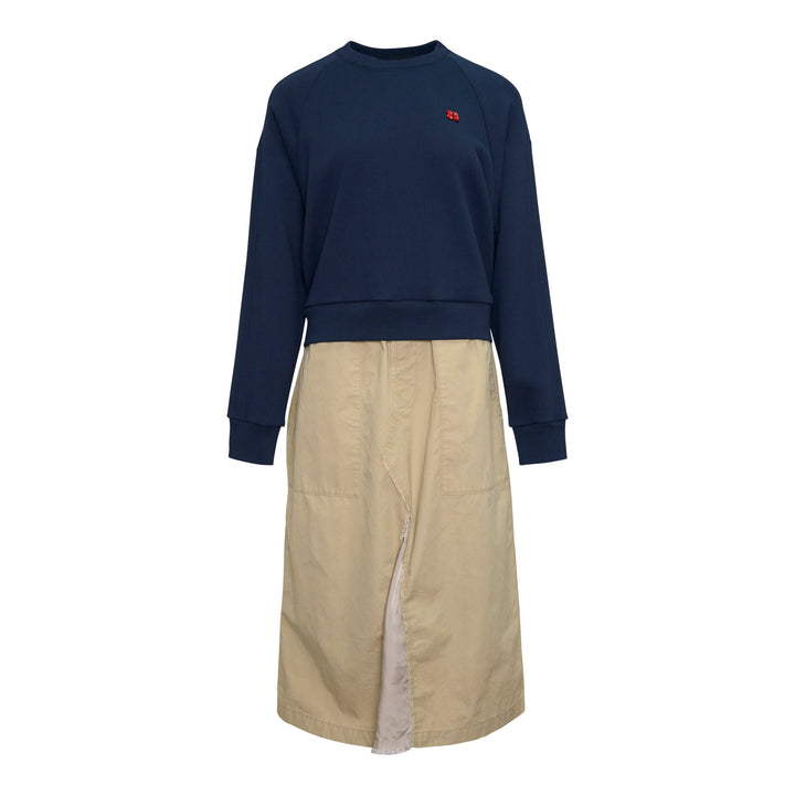Undercover Trompe L'Oeil Sweater Dress featuring a navy raglan sweatshirt top with small embroidered chest motif over a khaki twill midi skirt with front vent and patch pocket, presented as a single garment