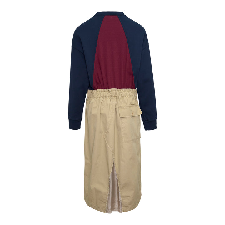 Undercover Trompe L'Oeil Sweater Dress featuring a navy raglan sweatshirt top with small embroidered chest motif over a khaki twill midi skirt with front vent and patch pocket, presented as a single garment
