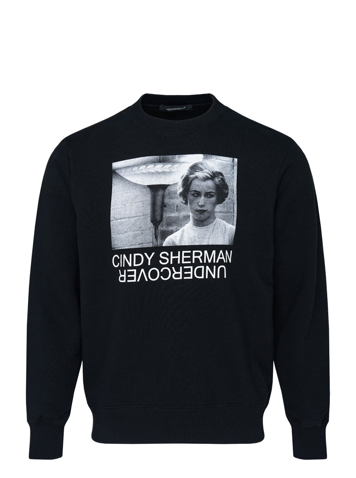 Undercover x Cindy Sherman black crewneck sweatshirt with a monochrome photographic print of a woman and mirrored Undercover logo on the chest