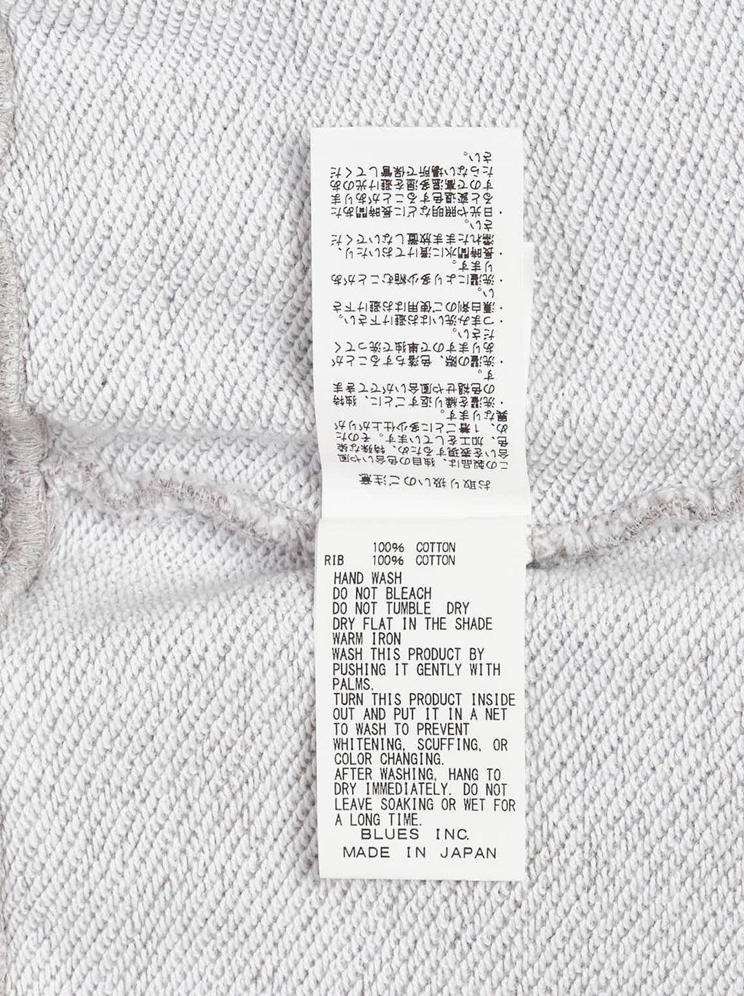 Grey marl crewneck sweatshirt with an illustrated fox in a patchwork denim jacket and jeans and Kuro Kitsuné Paris lettering on the chest - view 3