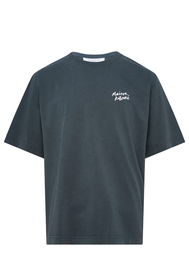 Maison Kitsuné Handwriting Short Sleeve Tee in washed slate blue with embroidered script logo at the chest, shown front-facing on a plain white background