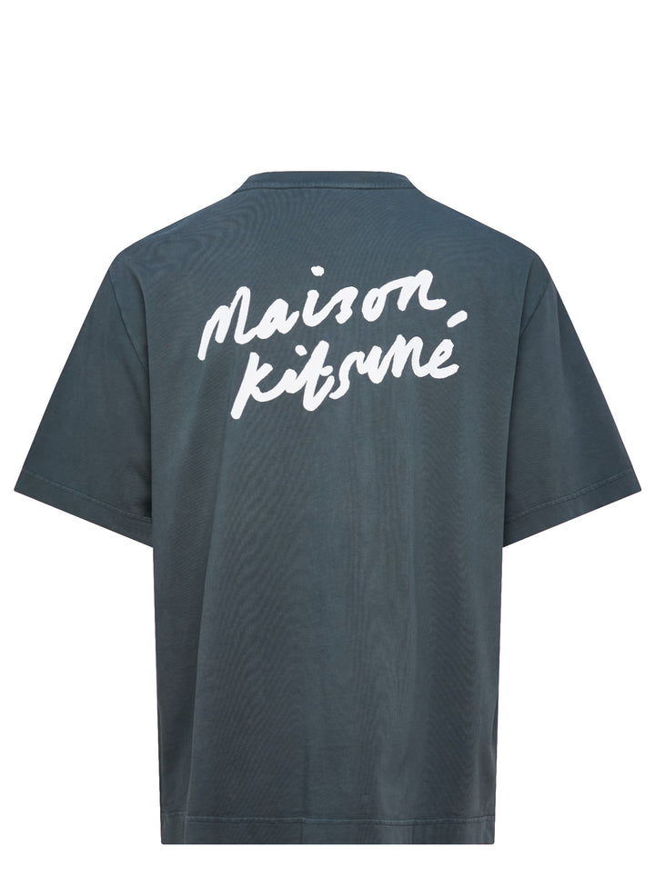 Maison Kitsuné Handwriting Short Sleeve Tee in washed slate blue with embroidered script logo at the chest, shown front-facing on a plain white background - view 2