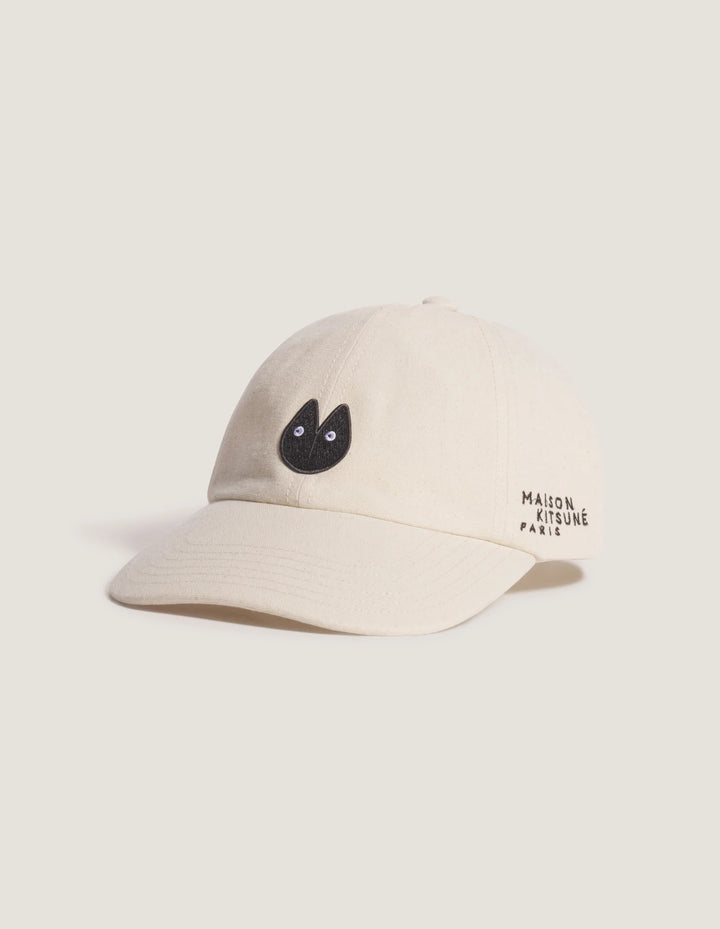 Maison Kitsuné Fortune Fox Cap in cream with an embroidered black fox head patch on the front and a curved brim - view 2