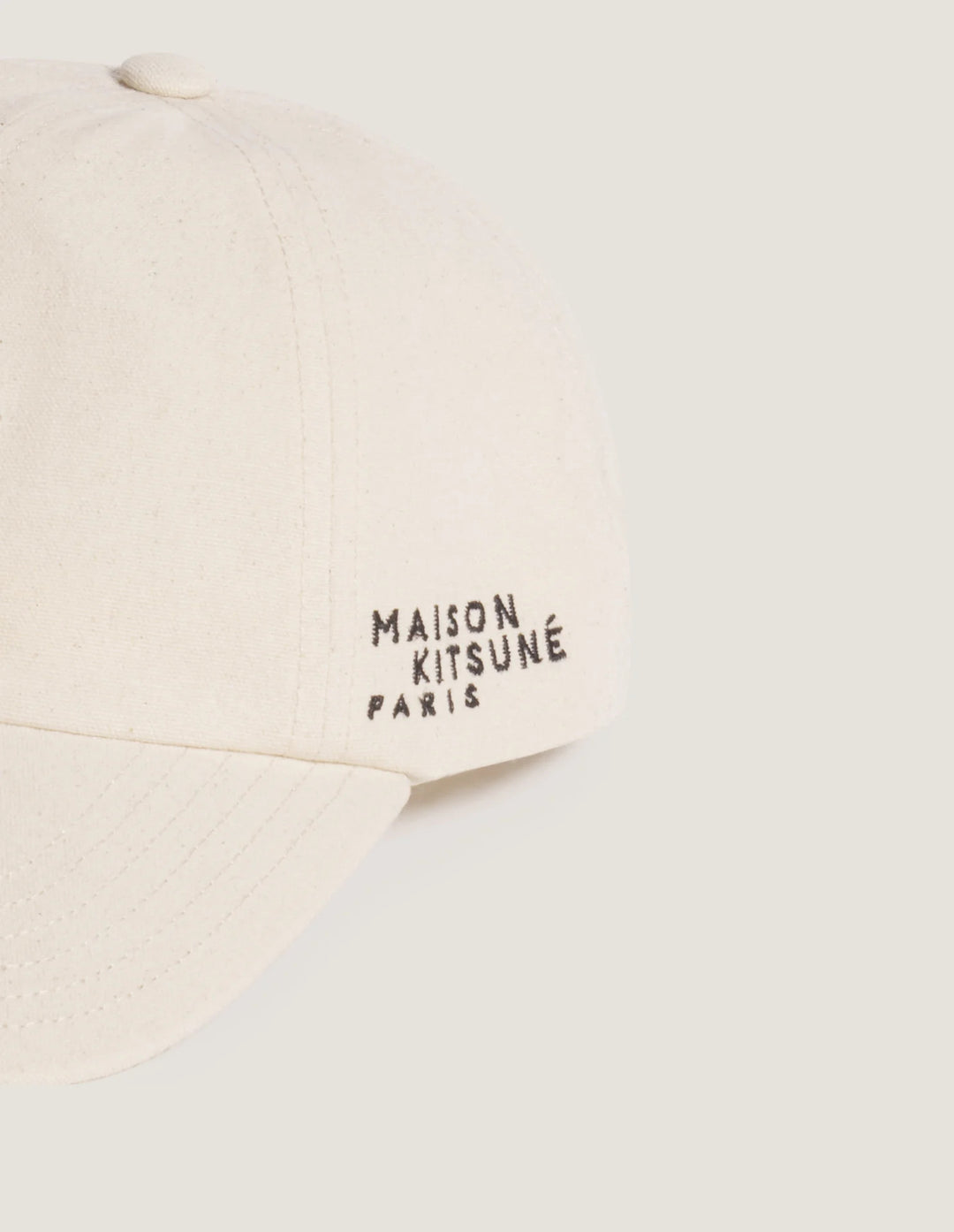 Maison Kitsuné Fortune Fox Cap in cream with an embroidered black fox head patch on the front and a curved brim - view 4
