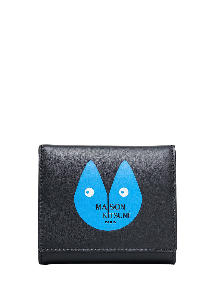Black leather Maison Kitsuné trifold wallet with a blue fox-face graphic and Maison Kitsuné Paris logo on the front