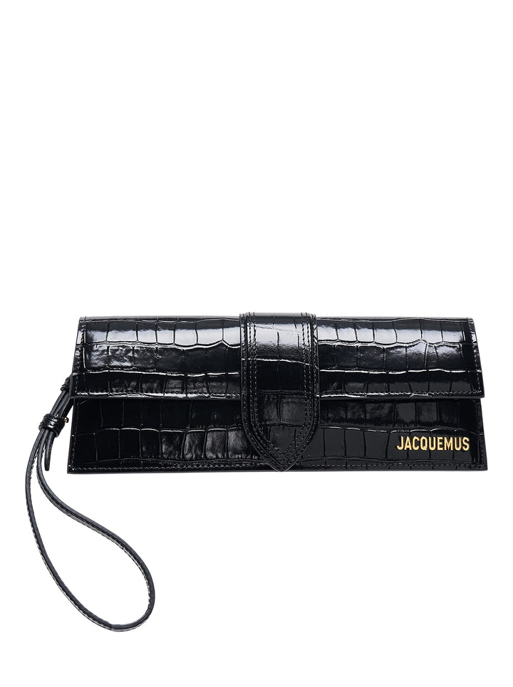 Jacquemus Le Bambino Long clutch in black glossy croc-embossed leather with front strap closure, gold logo lettering and wrist strap