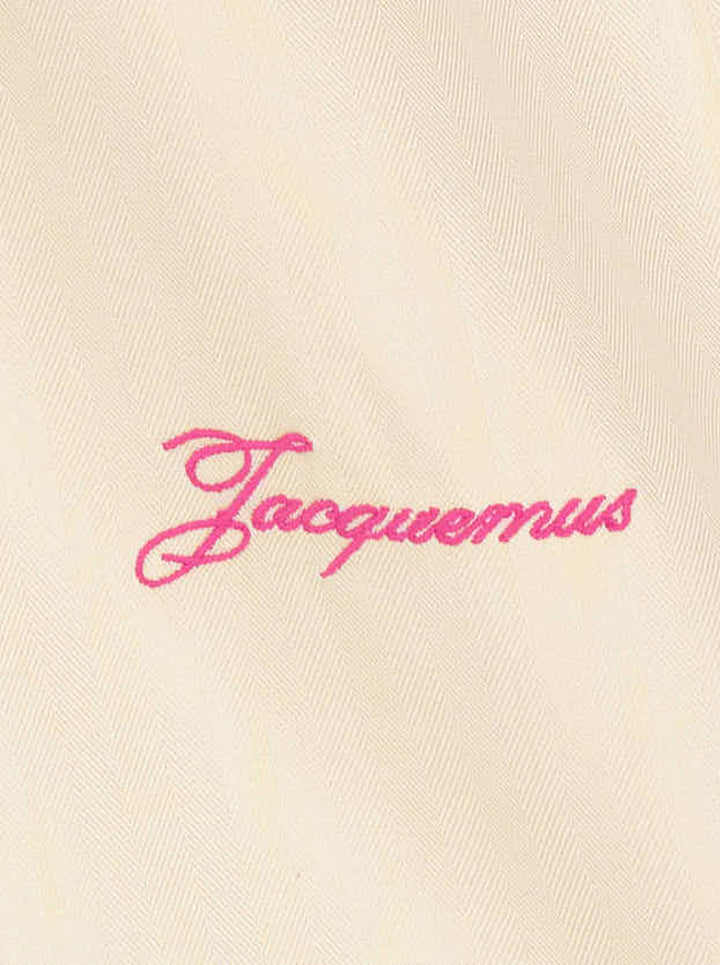 Jacquemus oversized pale yellow button-down shirt with chest patch pocket and pink script logo embroidery at the hem - view 3