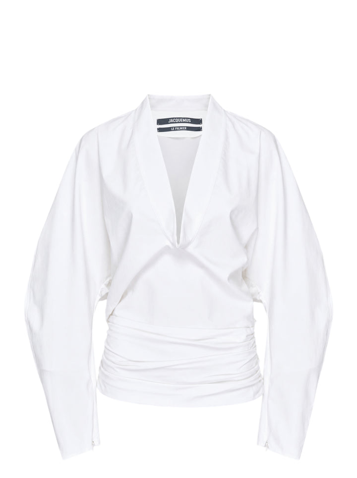 Jacquemus La Blouse Colombe white woven blouse with plunging V-neckline, voluminous sleeves and ruched waist