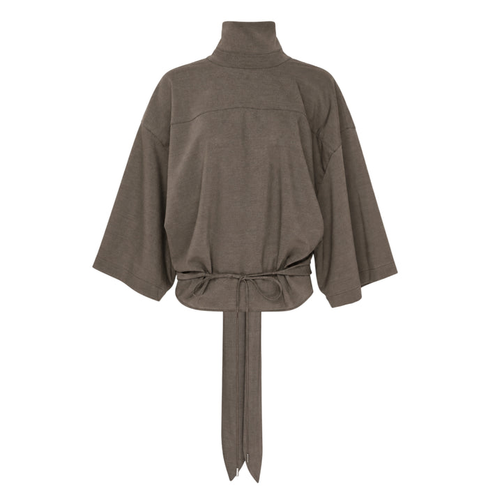 Jacquemus Havana Woven Belted Top in taupe, featuring a high turtleneck collar, wide elbow-length sleeves, and a long self-tie fabric belt at the gathered hem, displayed flat on a white background